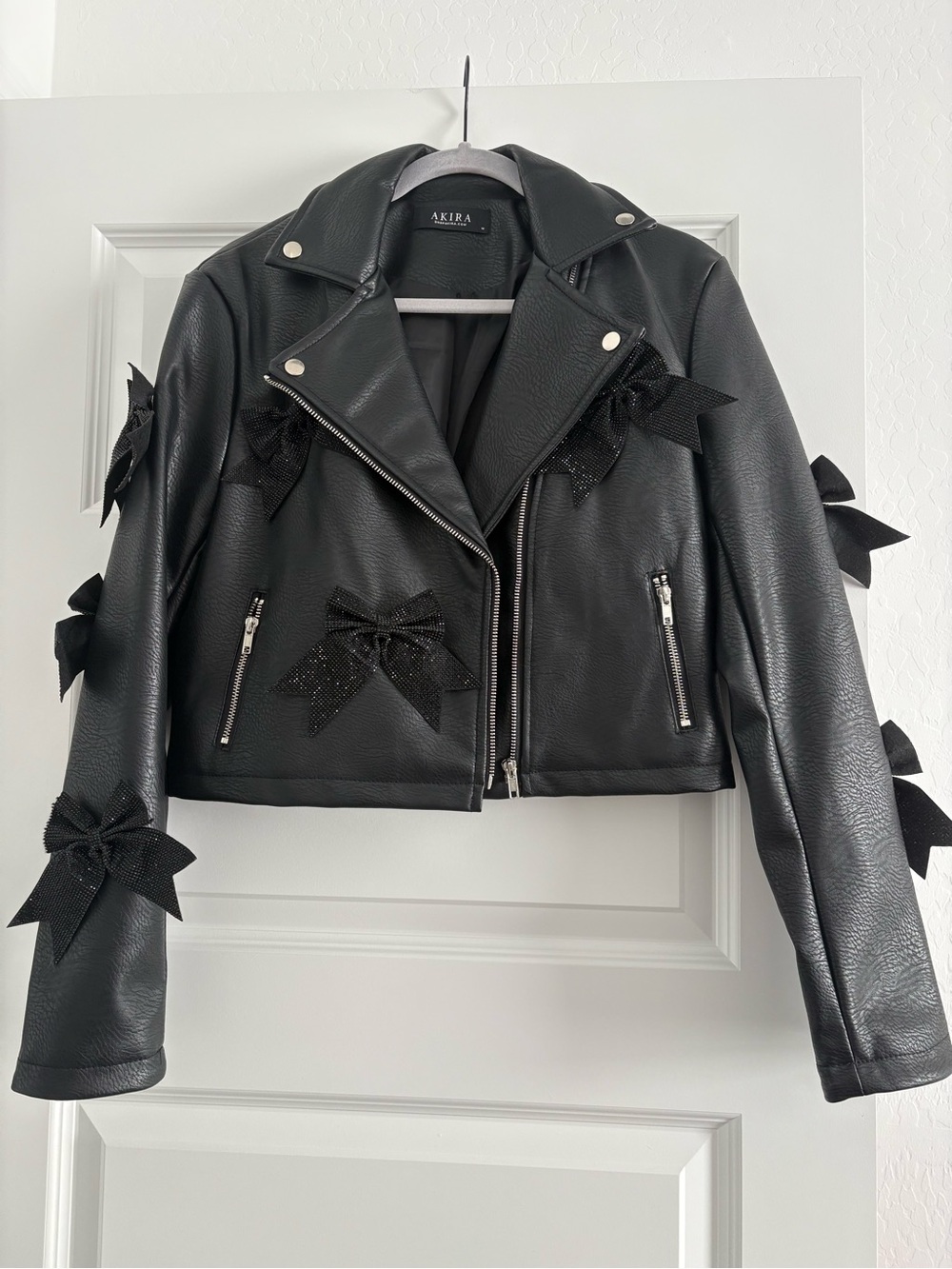 AKIRA Black Faux Leather Bow-Embellished Moto Jacket